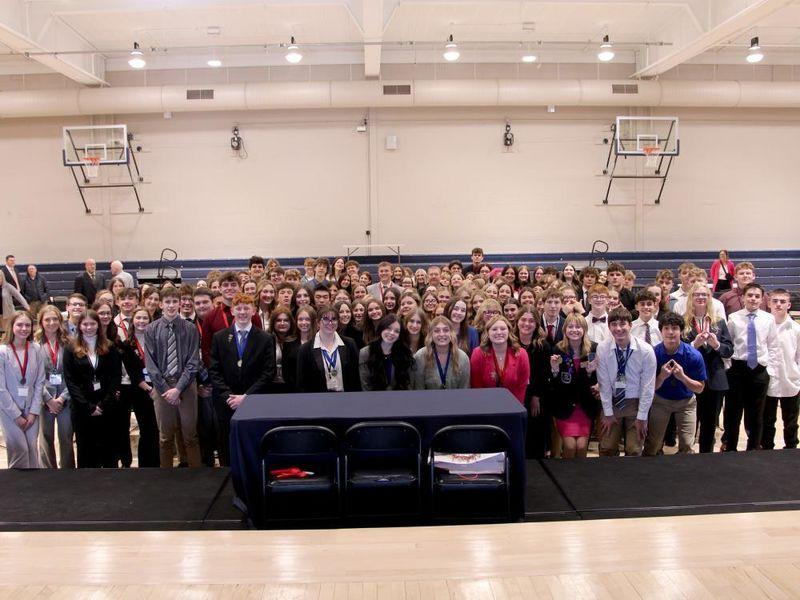 All students who participated in the 2024 Pennsylvania DECA District 1 conference gather for a group photo on the gym floor at the PAW Center, on the campus of Penn State DuBois.